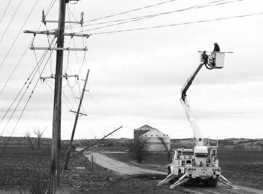 LINEMEN with Howard Greeley Rural Public Power district survey the damage to energy infrastructure along Odell Road just off of Highway 11 near Elba on Saturday morning. Photos by Michael Rother