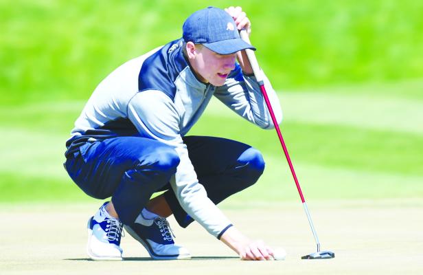SAM WELLS lines up a shot during his final nine holes last Tuesday afternoon at Meadowlark Hills Golf Course in Kearney. Wells placed third at last week’s Kearney Catholic Invite. Photos by Jordan Coslor