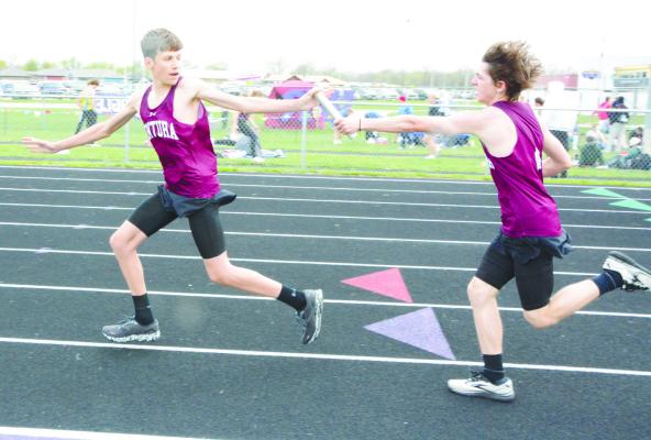 CENTURA’S Alec Plate hands off the baton to Kasen Webb during the boys’ 4x800-meter relay at the Lou-Platte Conference track meet on Friday. The Centurions placed sixth in that race.