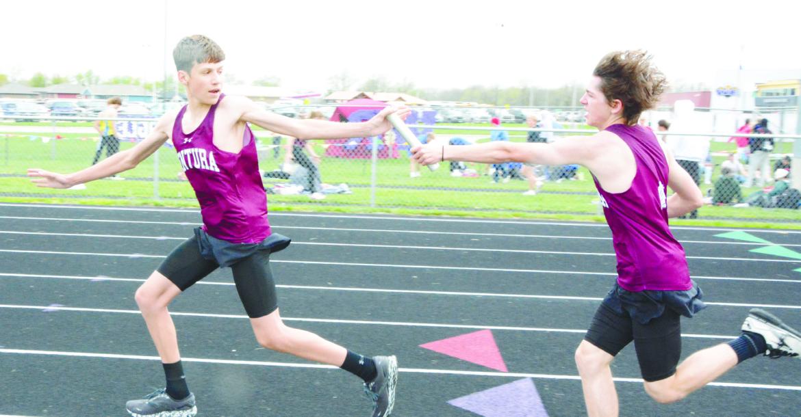 CENTURA’S Alec Plate hands off the baton to Kasen Webb during the boys’ 4x800-meter relay at the Lou-Platte Conference track meet on Friday. The Centurions placed sixth in that race.